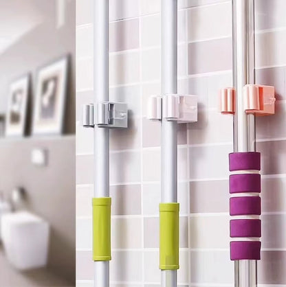 Colorful shower curtain hooks on a tiled bathroom wall.