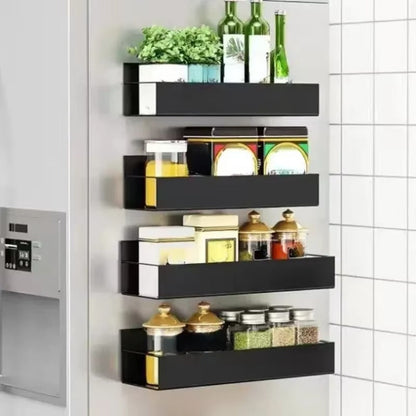 Black wall-mounted shelf with various items against a tiled wall.